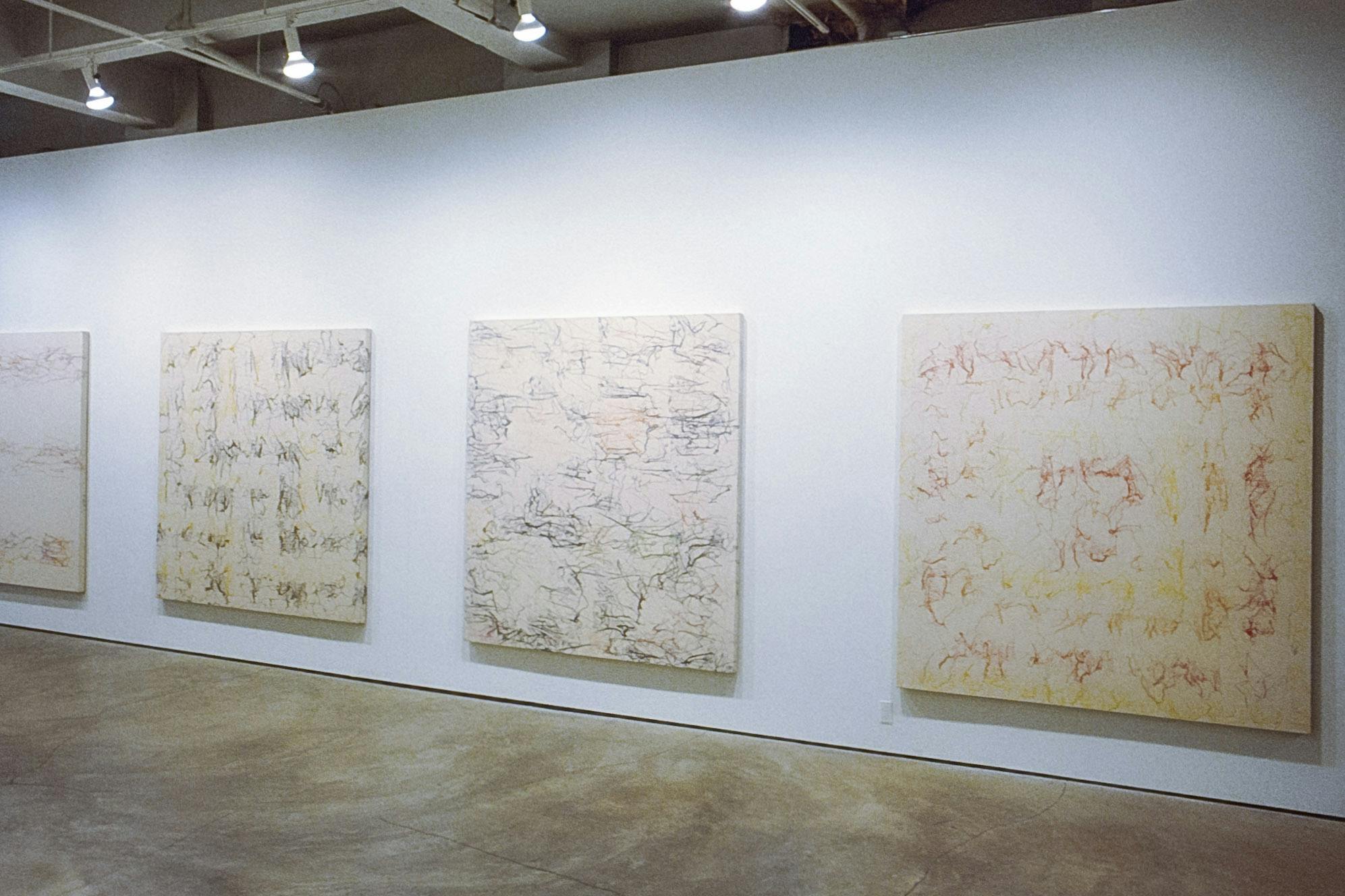 Four large drawings are installed on the gallery wall. On their identically-sized rectangle canvases, some abstract line drawings are made in various colours.  