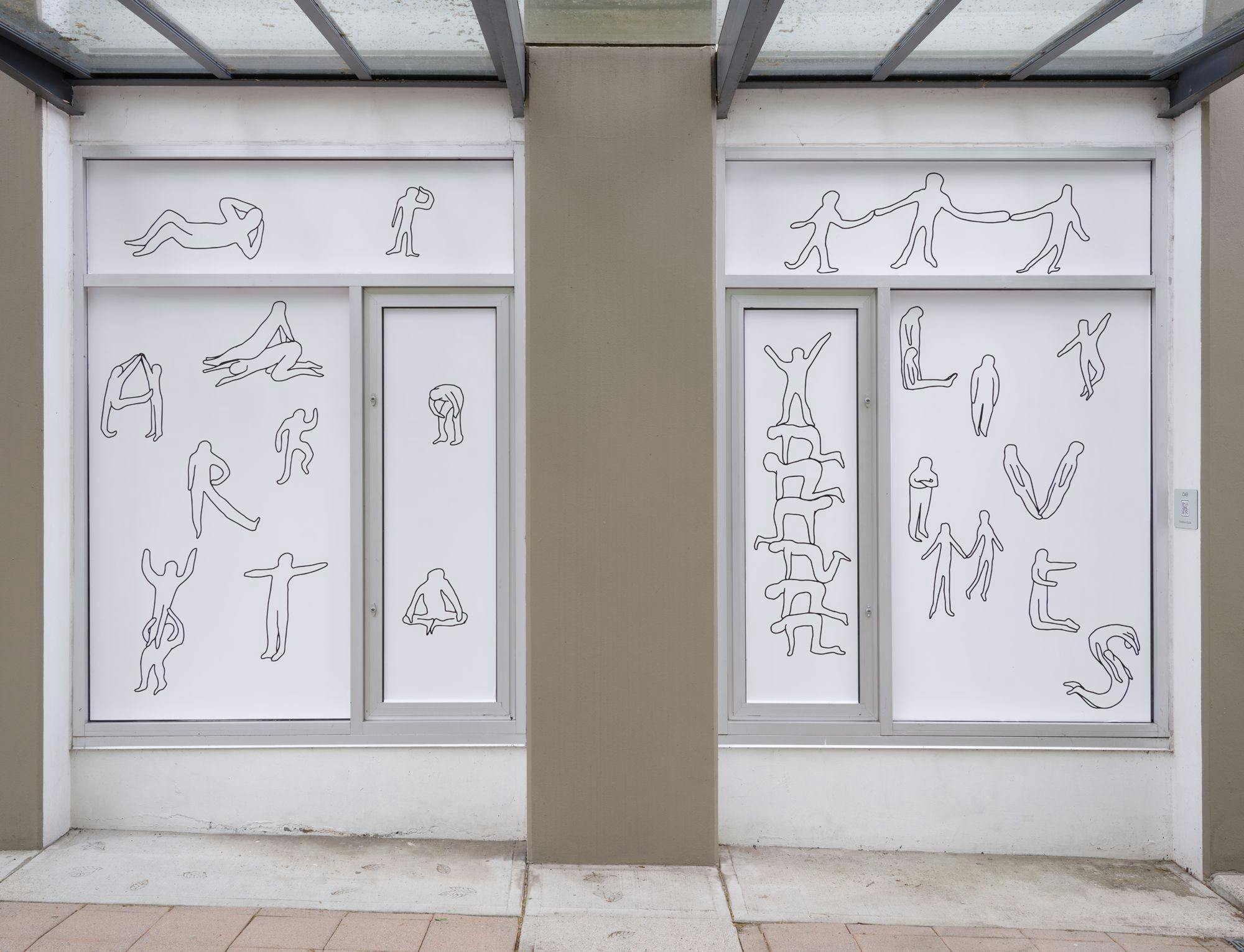 A pair of windows featuring line drawn figures engaged in various activities. Some of the figures spell out “art” and “lives” with their bodies.