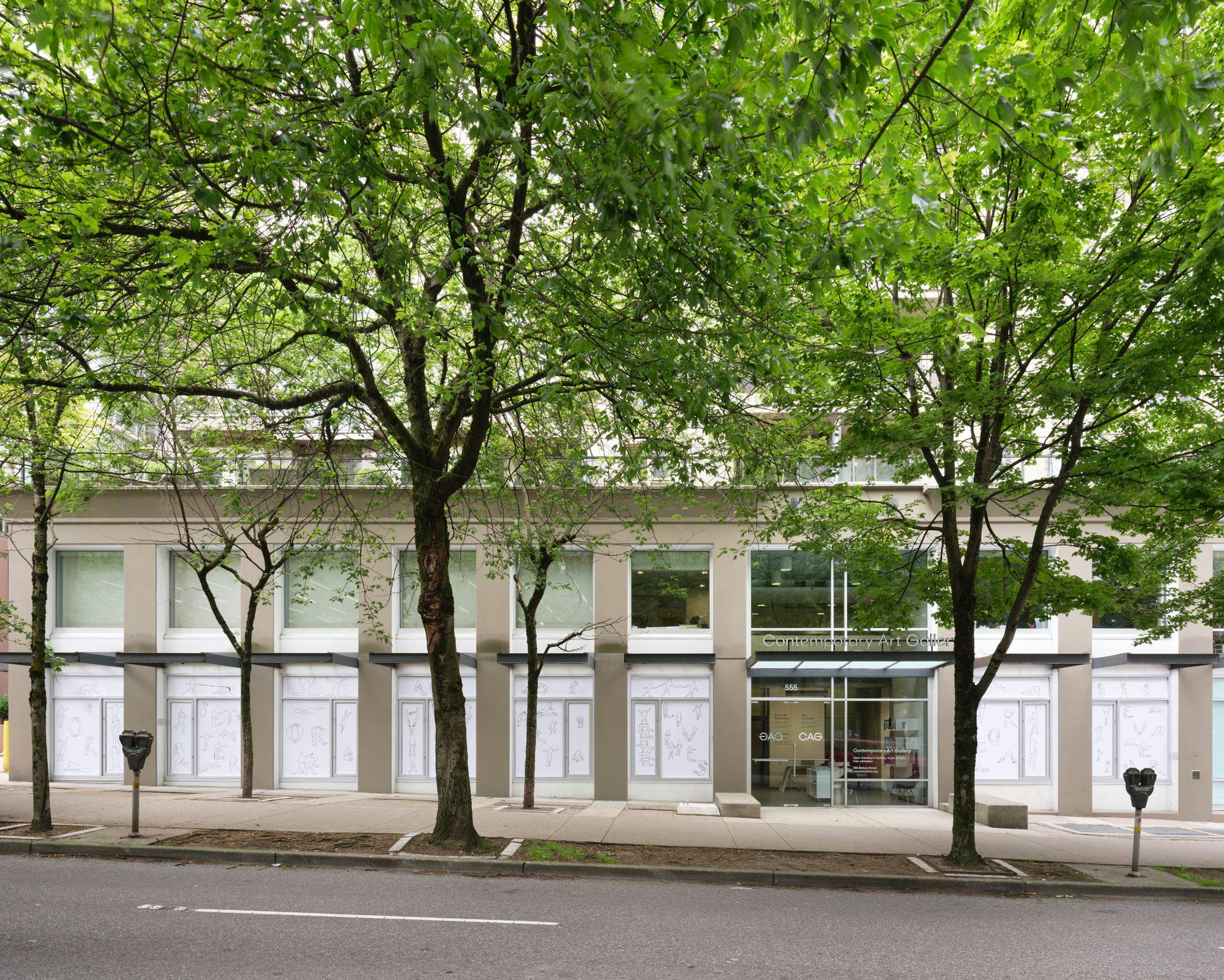 CAG’s façade with Kablusiak's Double Feature across eight street-facing windows. The artworks are line drawn figures engaged in various activities. Some of the figures spell out words with their bodies.