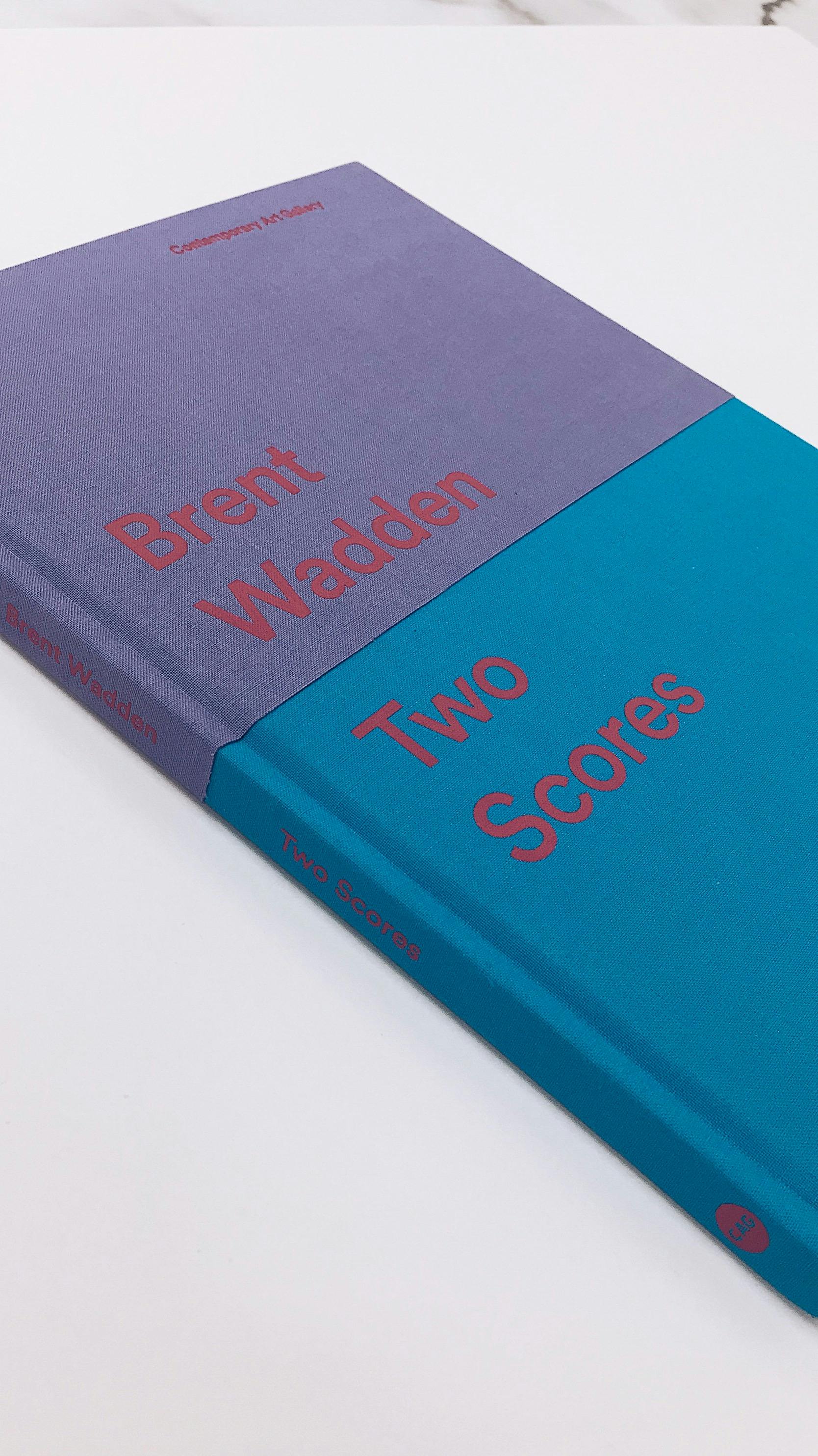 Brent Wadden's book, titled "two scores." The upper half of the book cover is purple and the bottom is blue. 